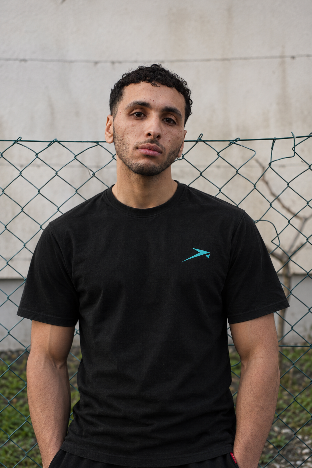 Street portrait in the black Beldi Dept. Performance T-Shirt with aquamarine logo