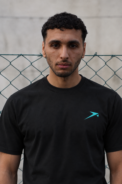Urban portrait in the black Beldi Dept. Performance T-Shirt with aquamarine logo